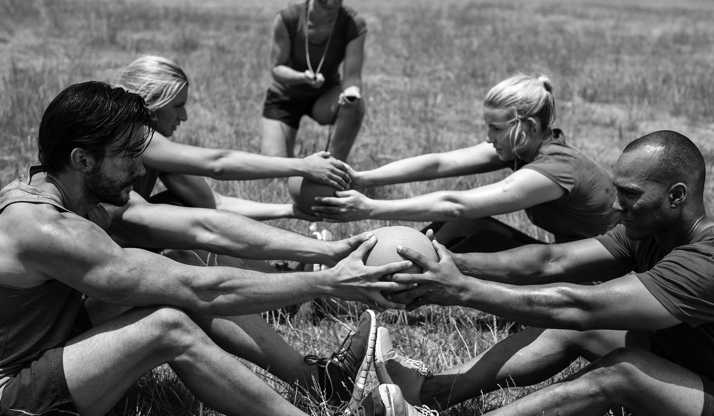 Fit people performing core exercise in bootcamp