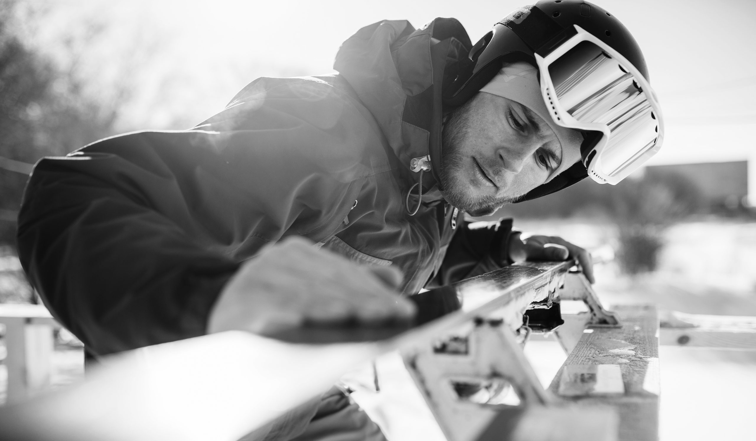 Male skier checks skis before skiing, closeup. Winter active sport, extreme lifestyle. Downhill skiing