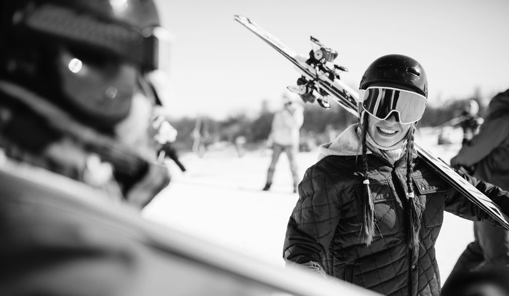 Skiers with skis and poles in hands, winter active sport. Skiing from mountains, extreme lifestyle