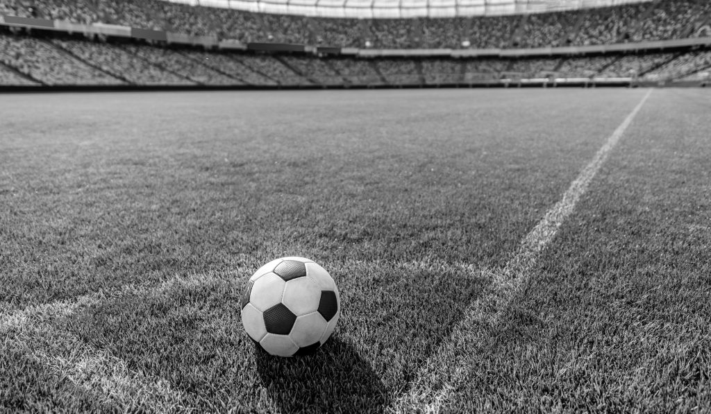 soccer ball on grass in corner kick position on soccer field stadium