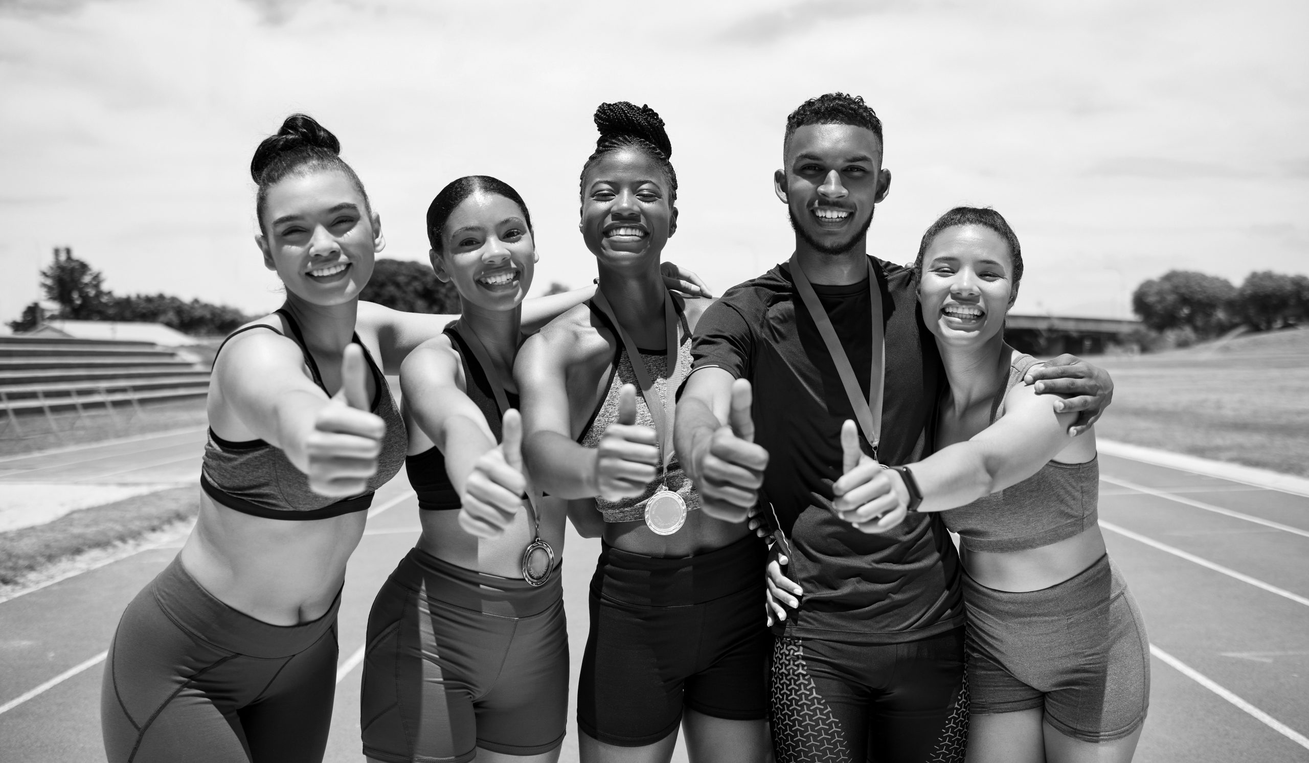 Team, thumbs up and sport winner with medal, runner and happy in portrait, success and win on race .